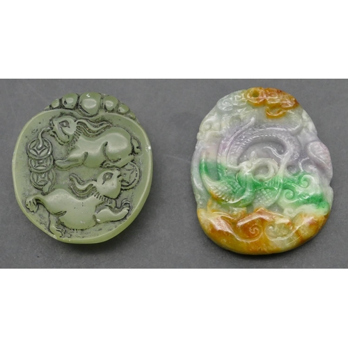 642 - An Oriental coloured hardstone amulet with raised dragon motif, 5cm high, also an oval jade style pe... 