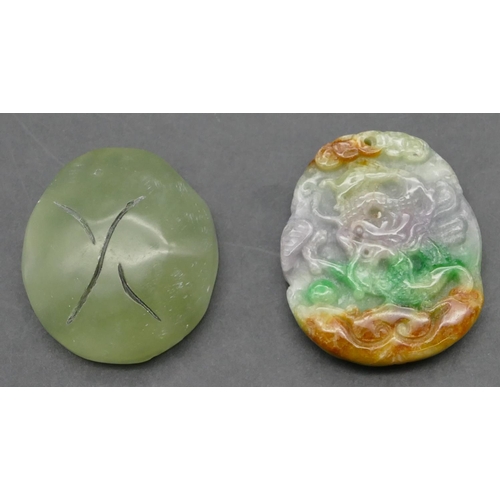 642 - An Oriental coloured hardstone amulet with raised dragon motif, 5cm high, also an oval jade style pe... 