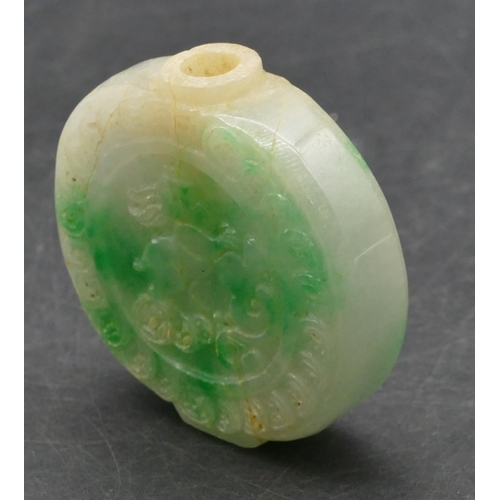 646 - An Oriental jade style hardstone snuff bottle with raised animal and carved decoration, 5.5cm high