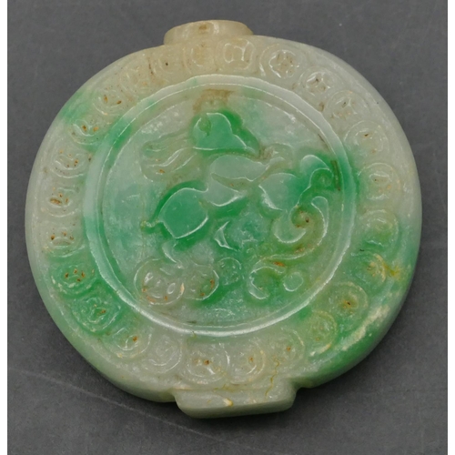 646 - An Oriental jade style hardstone snuff bottle with raised animal and carved decoration, 5.5cm high