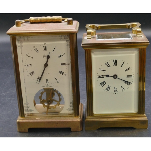 654 - A brass carriage clock with swing overhead handle, white enamelled dial and Roman numerals, fluted c... 