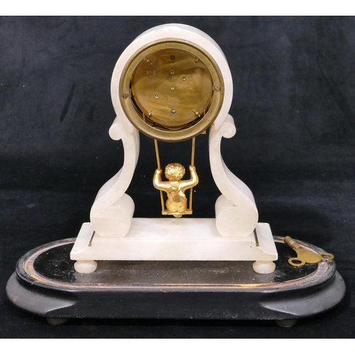 656 - A French alabaster timepiece with drum case, white enamel dial and Roman numerals, pendulum in the f... 