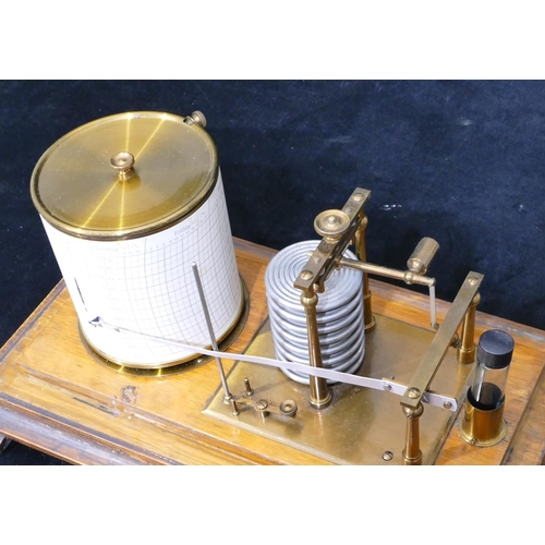 660 - A brass and oak barograph on splayed feet, 35cm wide