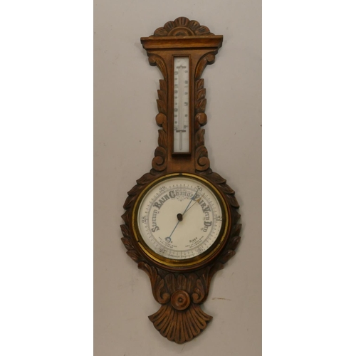 662 - A carved oak banjo barometer and thermometer with leaf and scroll decoration, 84cm high