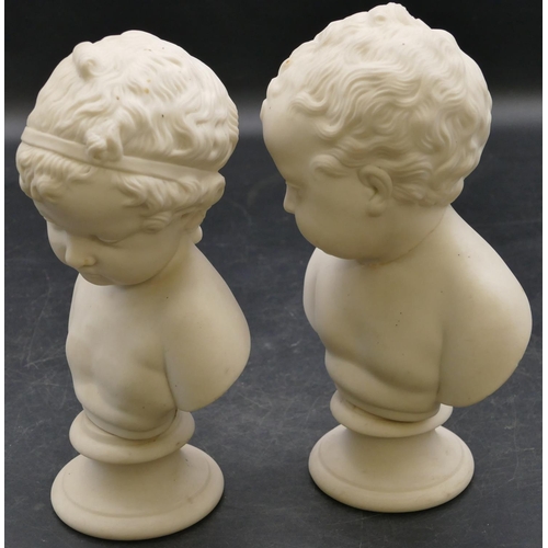 67 - 2 small bisque busts of children on round sweeping bases, 19cm high