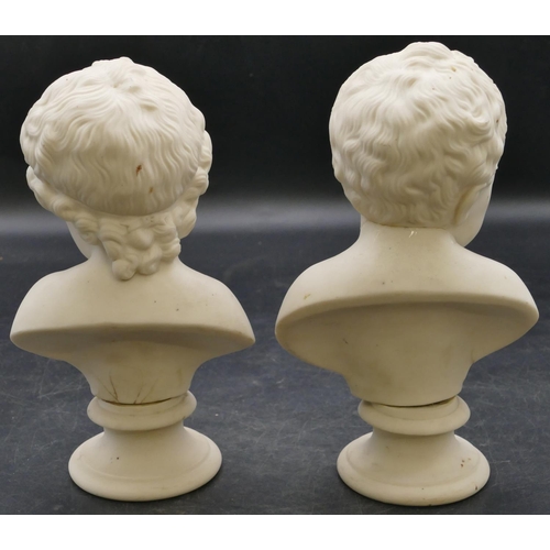 67 - 2 small bisque busts of children on round sweeping bases, 19cm high