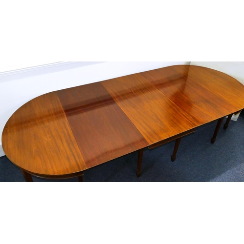 676 - An Edwardian mahogany triple pedestal D-end dining table with 2 additional leaves on square tapered ... 