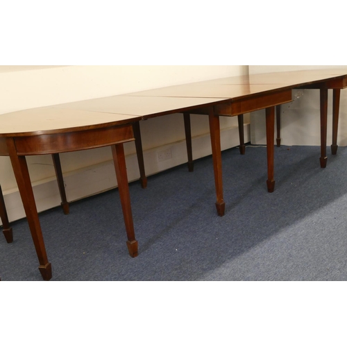 676 - An Edwardian mahogany triple pedestal D-end dining table with 2 additional leaves on square tapered ... 