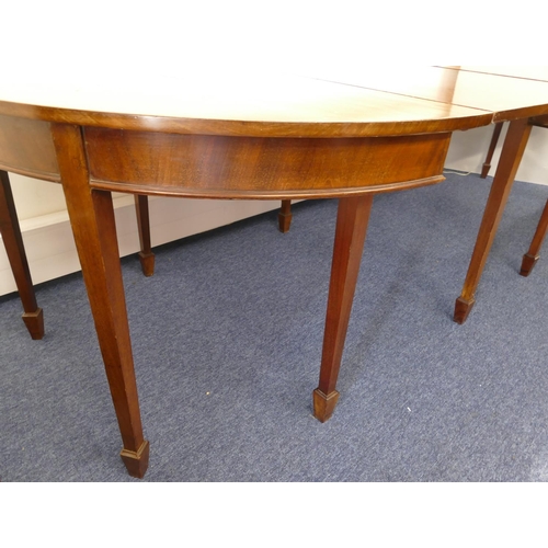 676 - An Edwardian mahogany triple pedestal D-end dining table with 2 additional leaves on square tapered ... 