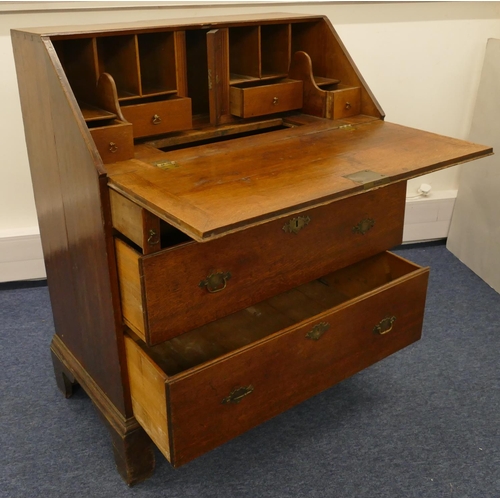 682 - An 18th Century small oak bureau with fall front, enclosing well, panelled door, secret compartments... 