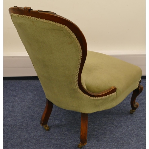 692 - A Victorian walnut spoon back nursing chair with green velvet overstuffed seat and button back, rais... 