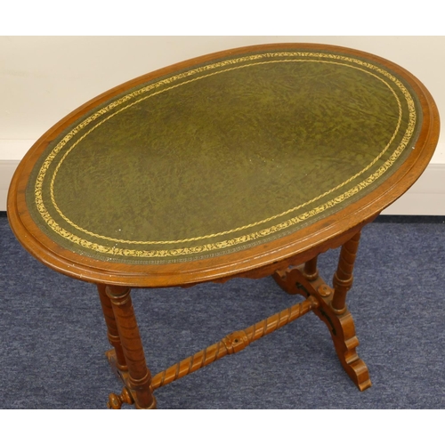 694 - A Victorian walnut oval occasional table with green leather inset top, double turned fluted end supp... 