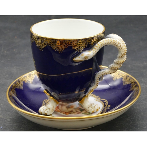 70 - A Meissen cabinet cup and saucer on royal blue ground with panels of cupids and allover gilt decorat... 