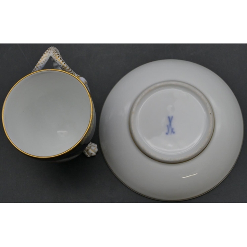 70 - A Meissen cabinet cup and saucer on royal blue ground with panels of cupids and allover gilt decorat... 