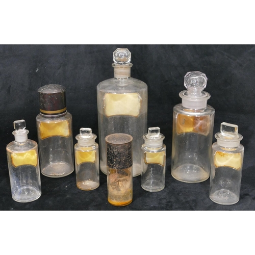 77 - 8 various round graduated clear glass chemist's bottles with stoppers/covers all with name plates, l... 