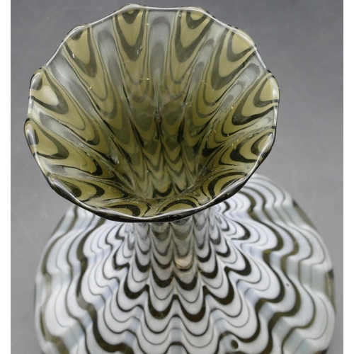 84 - A Loetz round bulbous thin necked trumpet shaped glass vase with white swirl decoration, 27cm high