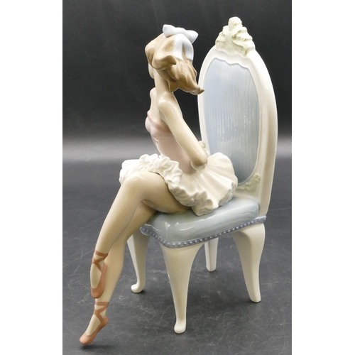 9 - A Lladro figure of a seated ballerina on chair, 23.5cm high