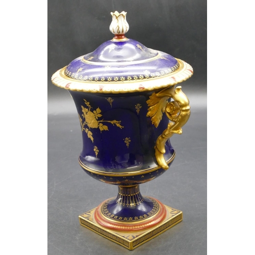 93 - An early 20th Century Royal Crown Derby round bulbous 2-handled urn shaped lidded pot on royal blue ... 