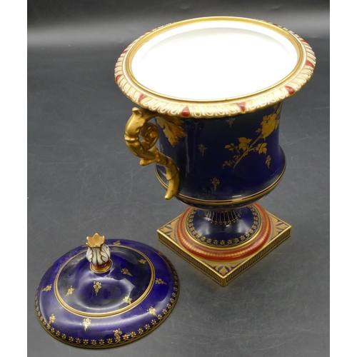 93 - An early 20th Century Royal Crown Derby round bulbous 2-handled urn shaped lidded pot on royal blue ... 