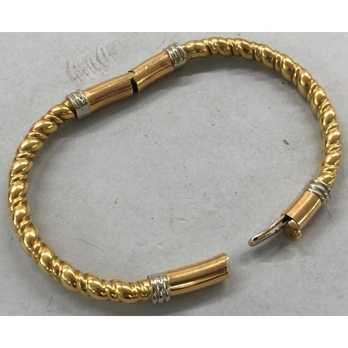 448 - An 18ct 3-coloured gold twist hinged bangle, inner measurement 6.5cm x 4.5cm, 20.6 grams gross