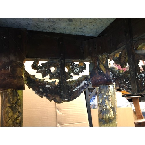 696 - An 18th Century and later carved gilt wood console table with green speckled marble top, carved frie... 