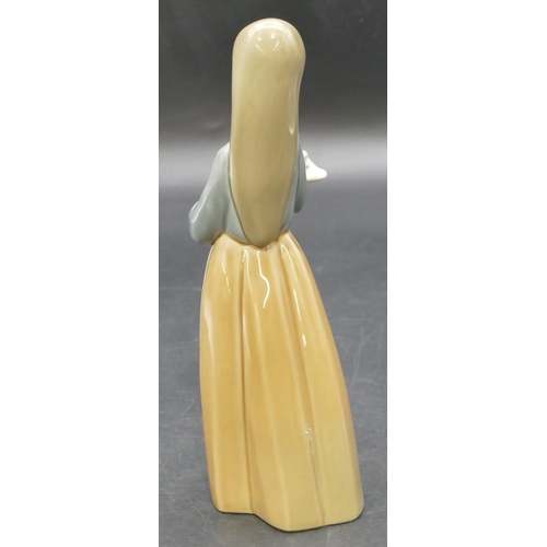 1 - A Lladro figure of a young standing lady holding a piglet, 17.5cm high