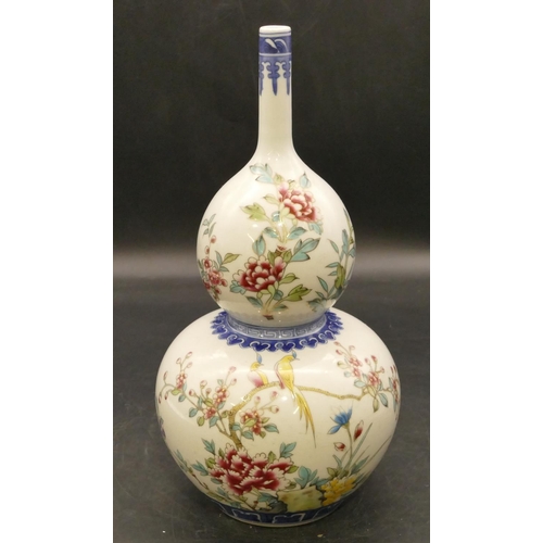 100 - An Oriental round gourd shaped vase on white and blue ground with multicoloured bird, branch and flo... 