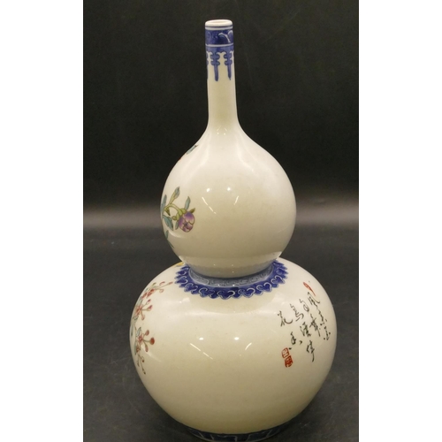 100 - An Oriental round gourd shaped vase on white and blue ground with multicoloured bird, branch and flo... 