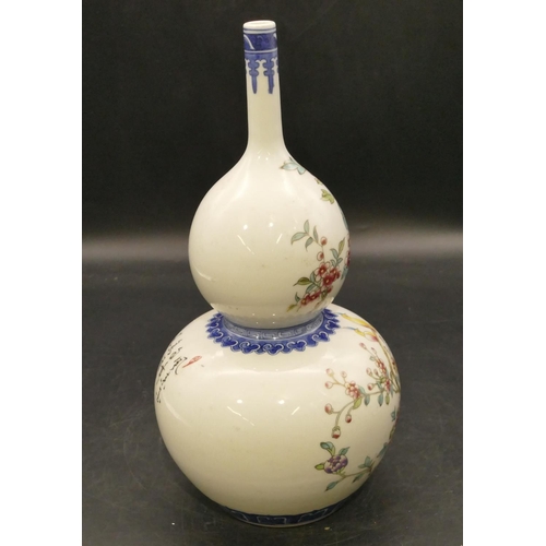 100 - An Oriental round gourd shaped vase on white and blue ground with multicoloured bird, branch and flo... 