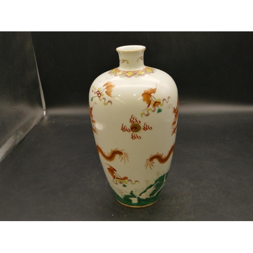 103 - An Oriental round bulbous thin necked vase on white and green ground with coloured dragon decoration... 