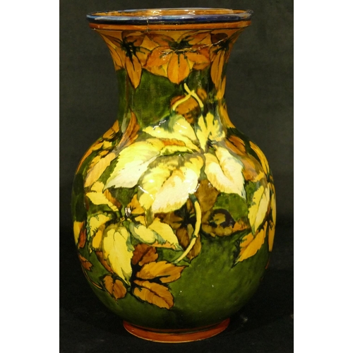 111 - A 19th Century glazed earthenware round bulbous thin necked trumped shaped vase on green and yellow ... 