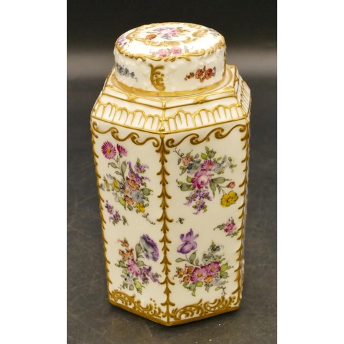 113 - A porcelain hexagonal shaped tea caddy with cover (cover cracked) on white ground with multicoloured... 