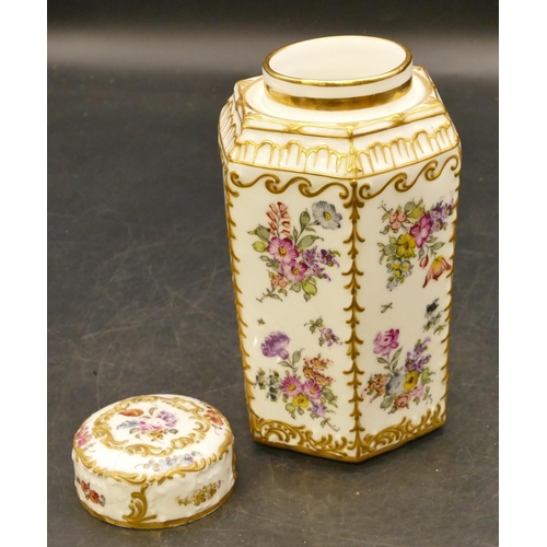 113 - A porcelain hexagonal shaped tea caddy with cover (cover cracked) on white ground with multicoloured... 