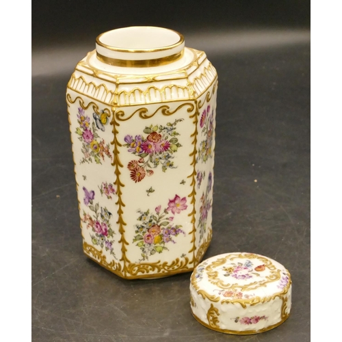 113 - A porcelain hexagonal shaped tea caddy with cover (cover cracked) on white ground with multicoloured... 