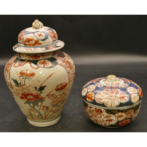 130 - A 19th Century Imari round bulbous shaped lidded pot on white, red and blue ground with floral, leaf... 