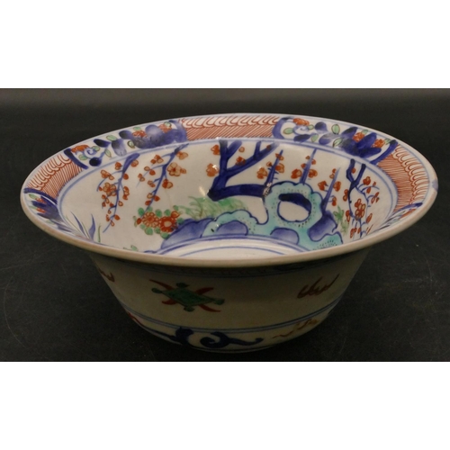 131 - An Oriental round trumpet shaped bowl on white, red and blue ground with floral, leaf and scroll dec... 