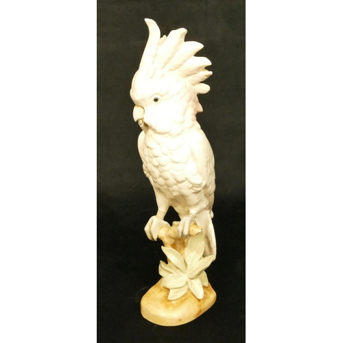 143 - A Royal Dux figure of a perched parrot, 41.5cm high (slight restoration to one feather)