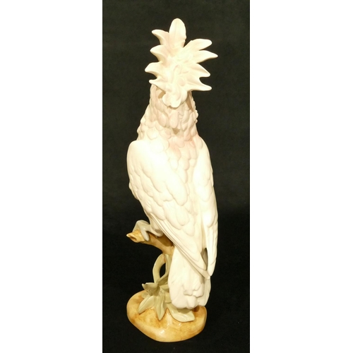 143 - A Royal Dux figure of a perched parrot, 41.5cm high (slight restoration to one feather)