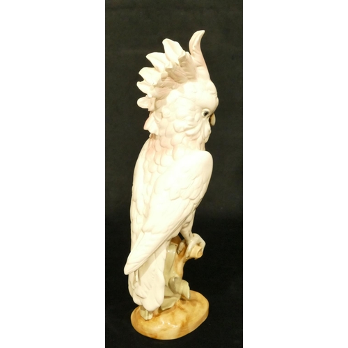 143 - A Royal Dux figure of a perched parrot, 41.5cm high (slight restoration to one feather)