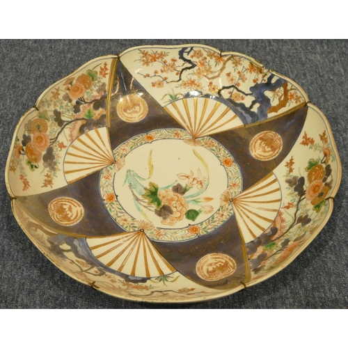 156 - A 19th Century Oriental round china scallop shaped charger on white and blue ground with multicolour... 