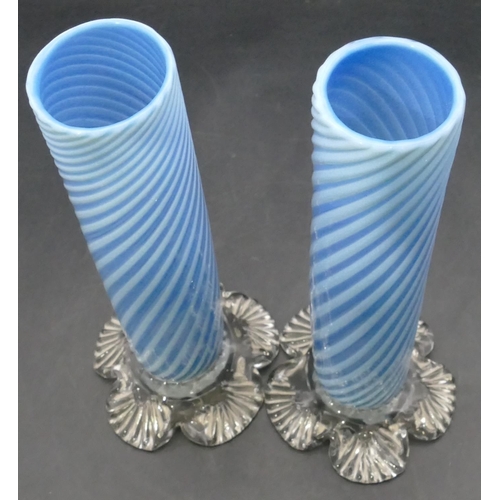 166 - A pair of pale blue opaline cylindrical vases with twist decoration on splayed leaf shaped bases, 25... 