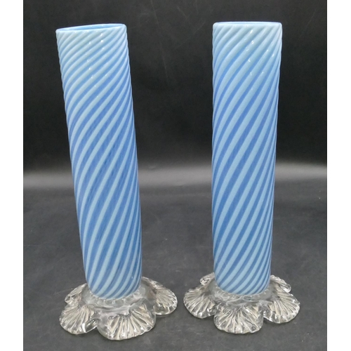 166 - A pair of pale blue opaline cylindrical vases with twist decoration on splayed leaf shaped bases, 25... 