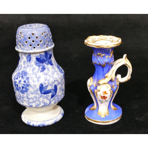 173 - A small china chamber candlestick on white and blue ground with multicoloured floral, leaf and gilt ... 