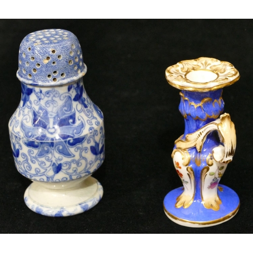 173 - A small china chamber candlestick on white and blue ground with multicoloured floral, leaf and gilt ... 