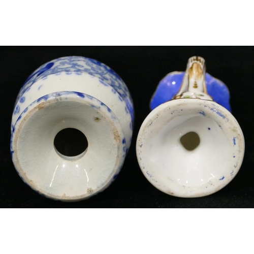 173 - A small china chamber candlestick on white and blue ground with multicoloured floral, leaf and gilt ... 