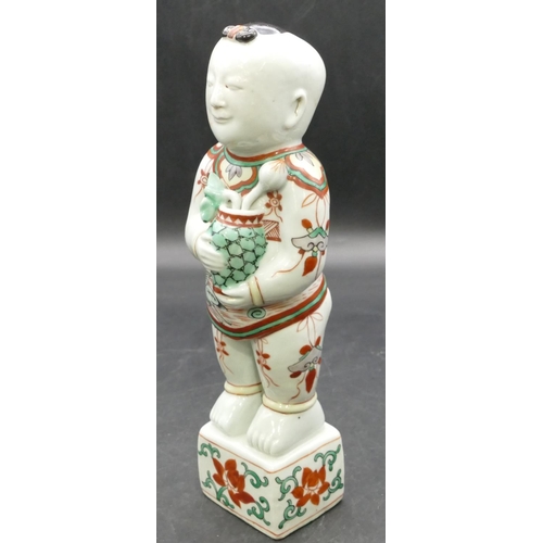 180 - A 19th Century Oriental figure of a standing gentleman holding a vase of flowers, on white, red and ... 