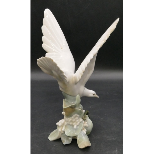 191 - A Lladro figure of a perched white bird with wings aloft, 27.5cm high