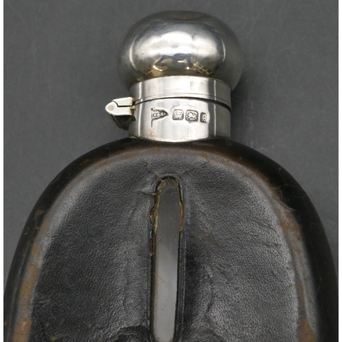 232 - A Victorian glass, leather and silver mounted concave shaped hip flask in detachable case, engraved ... 