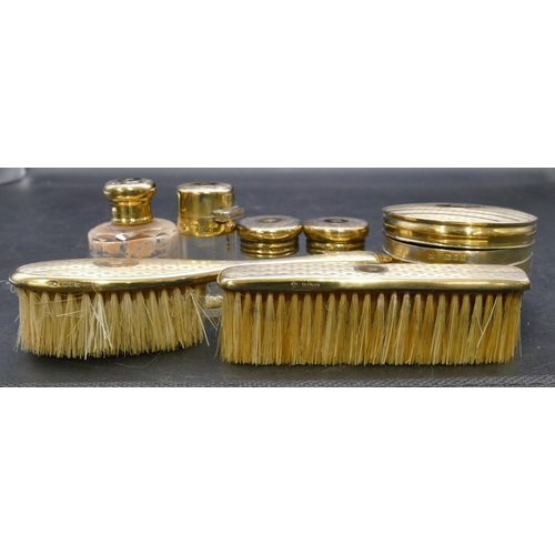 233 - A George V silver gilt travelling dressing table set, all with engine turned decoration, comprising ... 