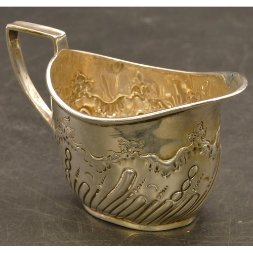 240 - A Sheffield silver oval cream jug with allover embossed decoration, maker's mark JD/WD, 6.5cm high, ... 